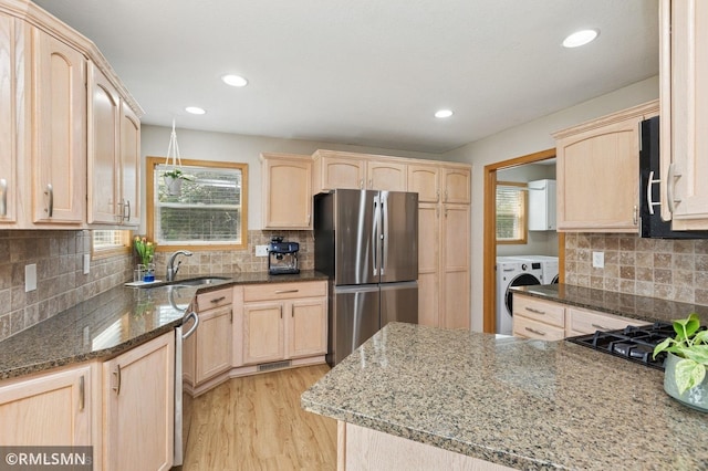 28942 Dawson Ave, Randolph, MN 55065 - kitchen with freestanding refrigerator, light brown cabinetry, washer / dryer, a sink, and recessed lighting