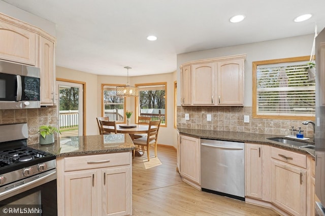 28942 Dawson Ave, Randolph, MN 55065 - kitchen featuring appliances with stainless steel finishes, light brown cabinetry, light wood-style flooring, backsplash, and a sink