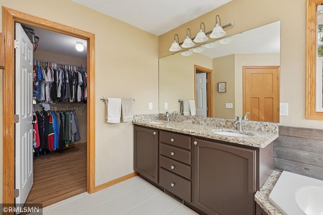 28942 Dawson Ave, Randolph, MN 55065 - full bath featuring baseboards, double vanity, tile patterned flooring, and a walk in closet