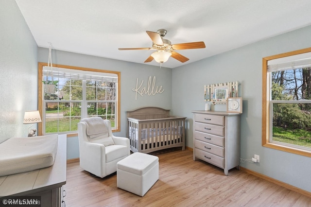 28942 Dawson Ave, Randolph, MN 55065 - bedroom with multiple windows, light wood finished floors, and a nursery area