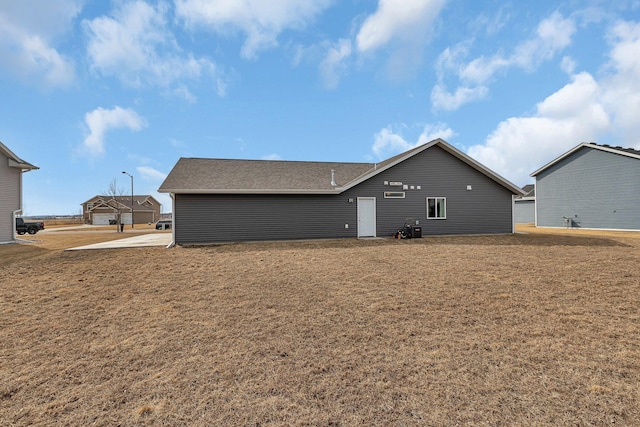 rear view of property featuring a yard