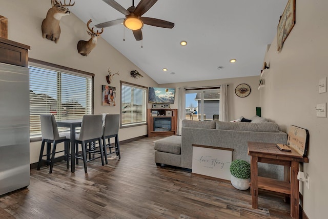 living room with recessed lighting, wood finished floors, baseboards, and a wealth of natural light