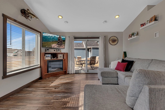 living room with recessed lighting, wood finished floors, baseboards, and vaulted ceiling