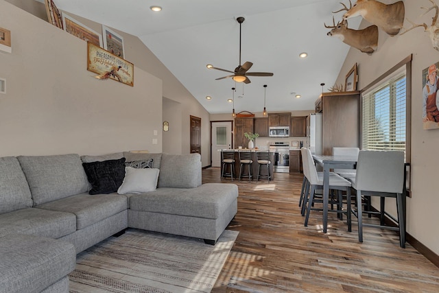 living room with baseboards, recessed lighting, wood finished floors, high vaulted ceiling, and a ceiling fan