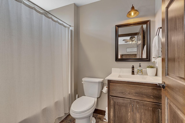 full bathroom featuring baseboards, toilet, vanity, and a ceiling fan