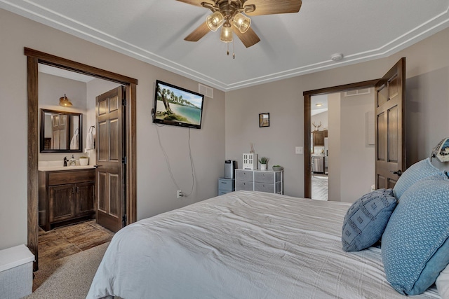 bedroom with ensuite bath, carpet flooring, visible vents, and ceiling fan