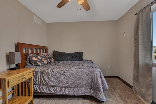 bedroom with visible vents, carpet floors, baseboards, and a ceiling fan