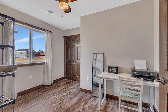 office area with visible vents, a ceiling fan, baseboards, and wood finished floors