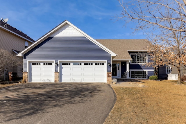 view of front of house with aphalt driveway and a garage