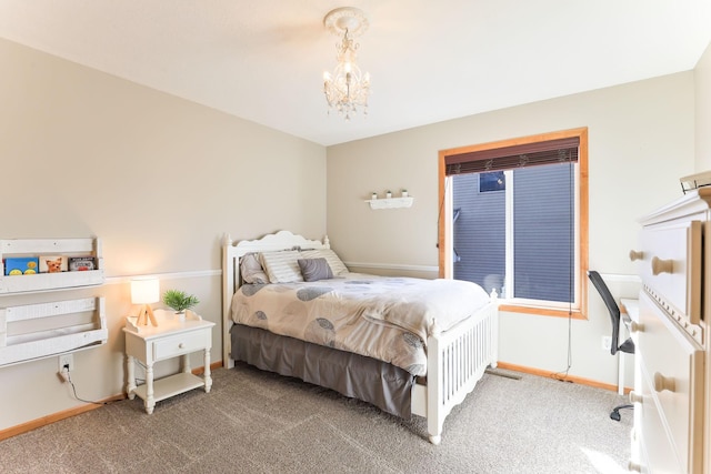 carpeted bedroom with baseboards and a notable chandelier