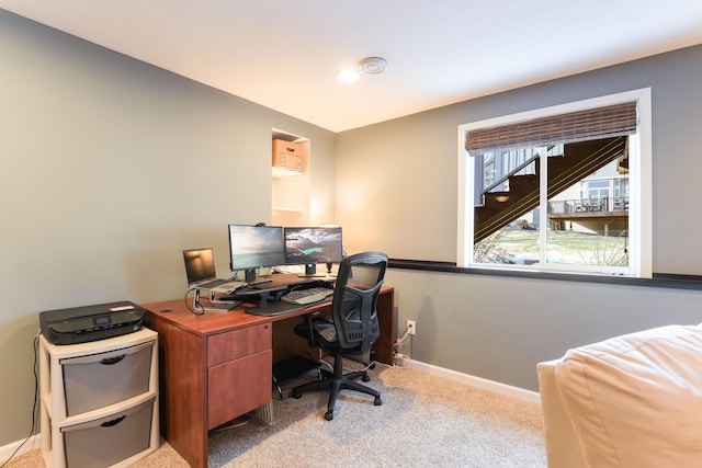 carpeted office featuring baseboards