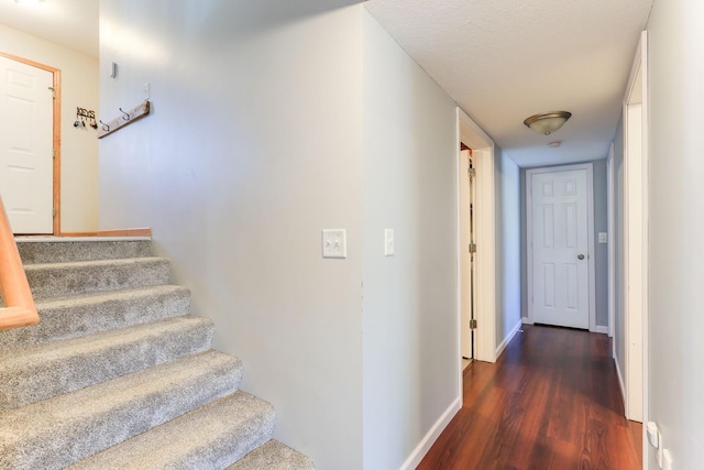 stairs with baseboards and wood finished floors