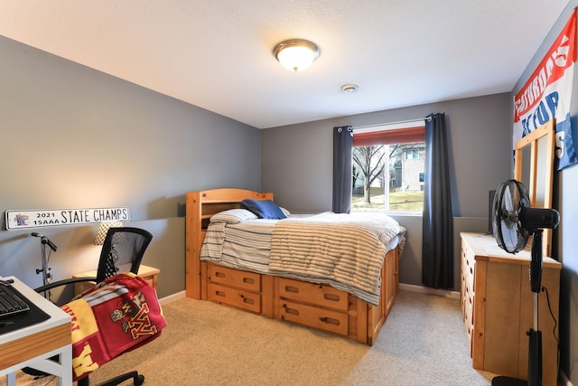 bedroom with baseboards and light colored carpet