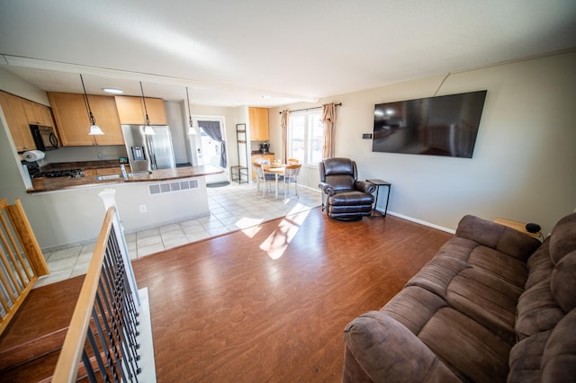 living room featuring light wood-style flooring and baseboards