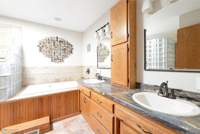 bathroom featuring a sink, a bath, and double vanity