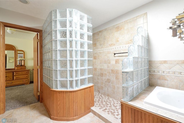 bathroom featuring tile patterned floors, a bath, and walk in shower