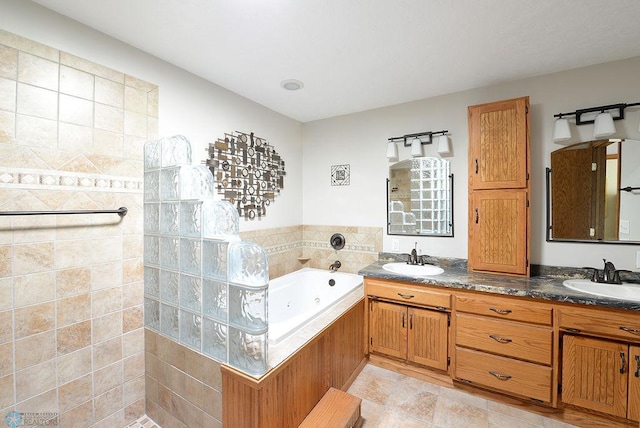 bathroom with double vanity, a jetted tub, a walk in shower, and a sink