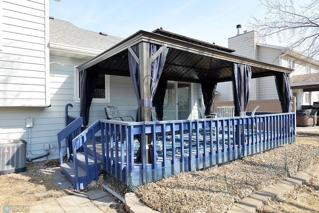 exterior space featuring a chimney, a shingled roof, and central AC