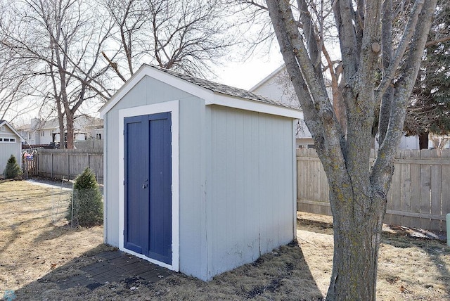 view of shed with a fenced backyard