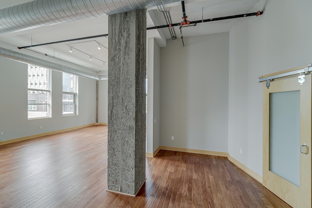 interior space with baseboards and wood finished floors