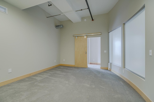 carpeted spare room with visible vents and baseboards