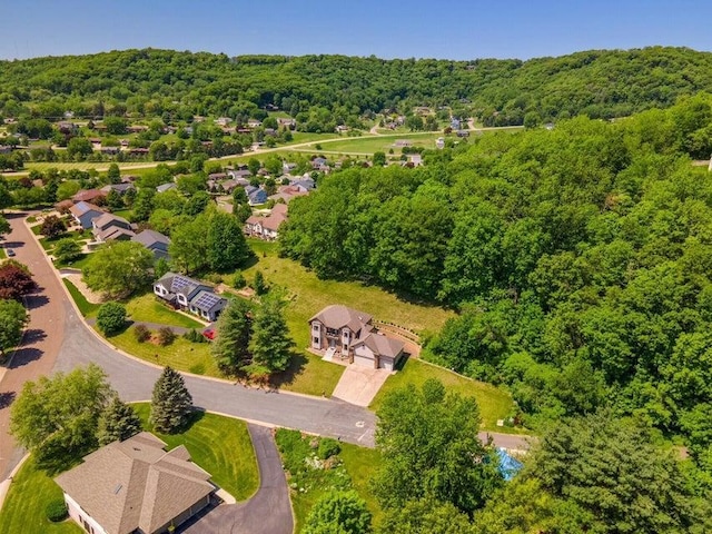 drone / aerial view with a residential view and a view of trees