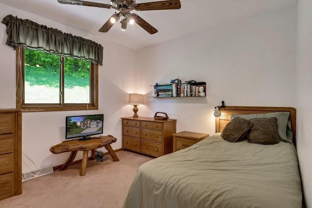 bedroom with visible vents, light carpet, baseboards, and a ceiling fan