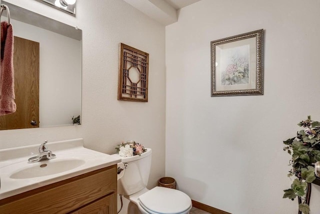 bathroom featuring vanity and toilet