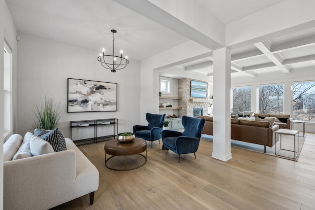 living room with beamed ceiling, coffered ceiling, wood finished floors, and a fireplace