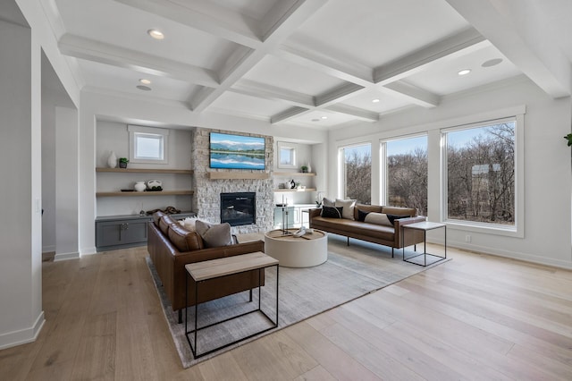 living room with beamed ceiling, coffered ceiling, and light wood-style flooring