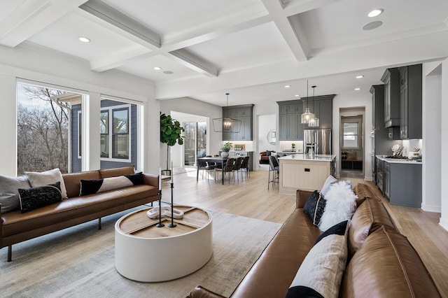 living area with beamed ceiling, recessed lighting, and light wood finished floors