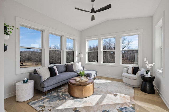 interior space featuring a healthy amount of sunlight, lofted ceiling, and a ceiling fan