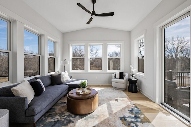 sunroom featuring a healthy amount of sunlight, a ceiling fan, and vaulted ceiling