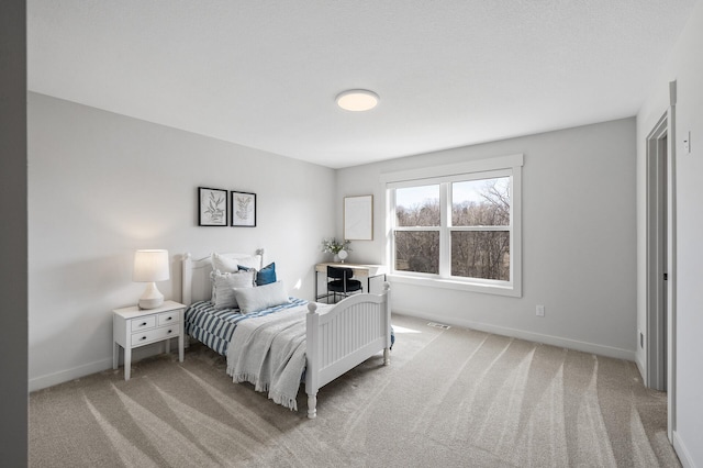 bedroom featuring visible vents, baseboards, and light colored carpet