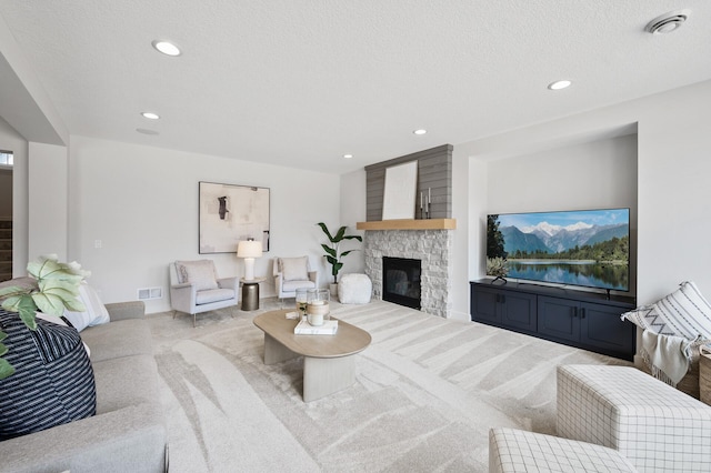 carpeted living room featuring a stone fireplace, recessed lighting, and visible vents