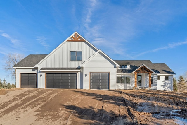 modern farmhouse style home with board and batten siding, a shingled roof, and dirt driveway