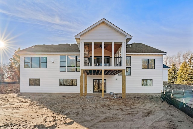 back of property with a ceiling fan