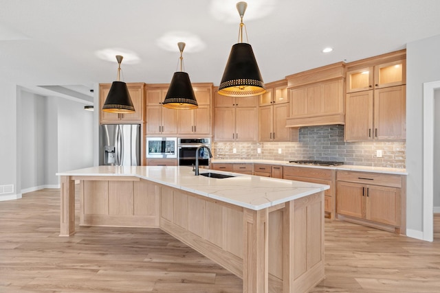 kitchen featuring a sink, stainless steel appliances, decorative backsplash, and light brown cabinets