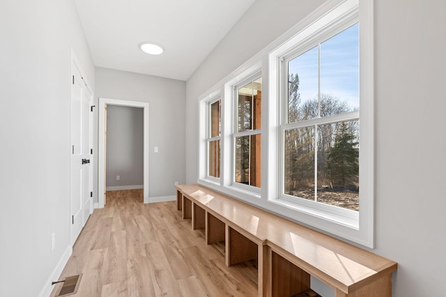 interior space with light wood-style floors, visible vents, and baseboards