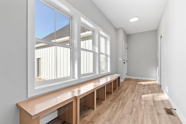 mudroom featuring visible vents, baseboards, and light wood-style flooring