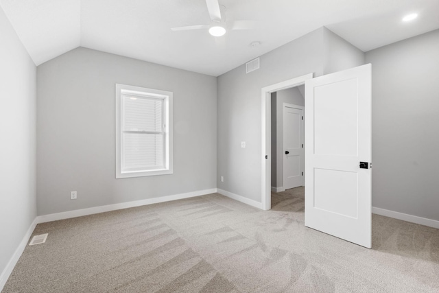 unfurnished bedroom featuring visible vents, baseboards, light carpet, and a ceiling fan