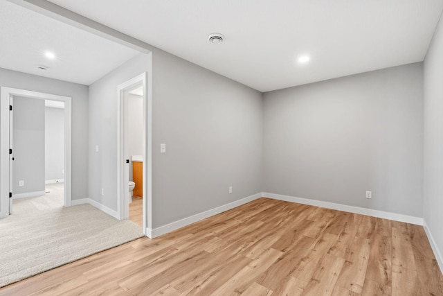 unfurnished room with recessed lighting, baseboards, and light wood-style flooring