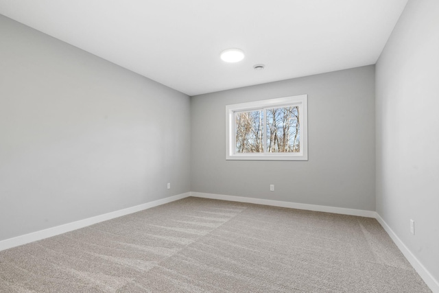 carpeted empty room with baseboards