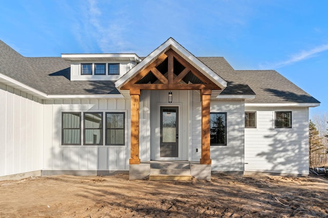 modern farmhouse style home featuring board and batten siding and a shingled roof