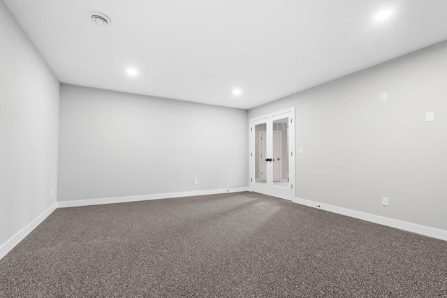 spare room with french doors, baseboards, and dark carpet