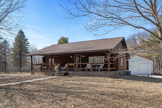 view of front facade with an outbuilding, central AC, covered porch, roof with shingles, and log exterior