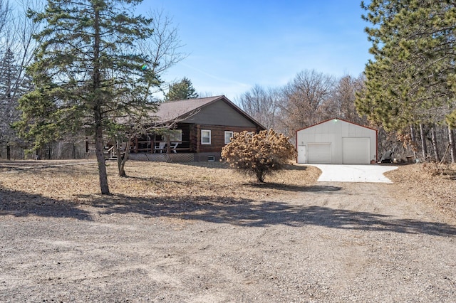 view of front of property featuring an outbuilding, driveway, and a garage