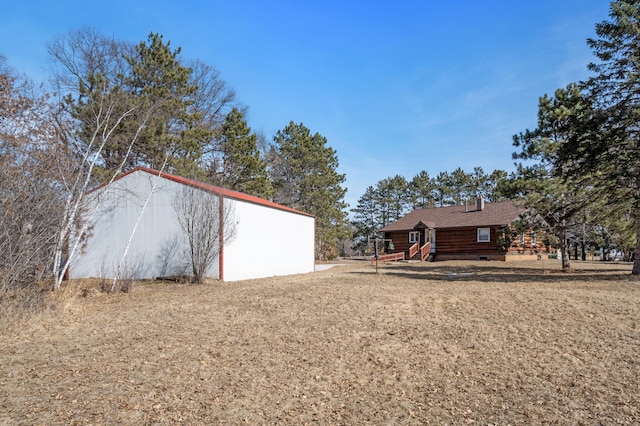 view of yard featuring an outbuilding and an outdoor structure