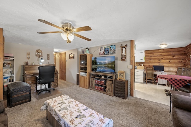 carpeted living area with ceiling fan, a textured ceiling, and log walls