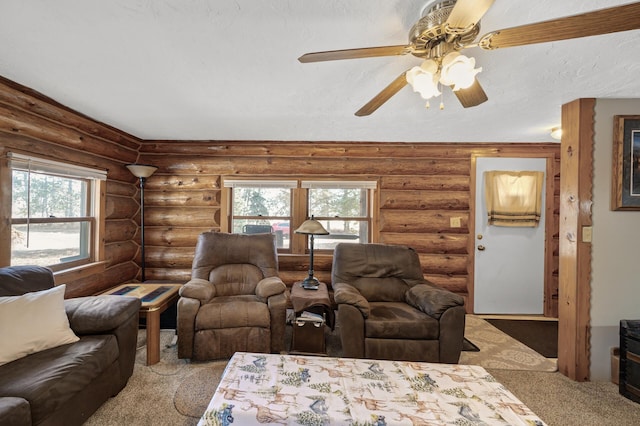 living room featuring a ceiling fan, carpet, and rustic walls